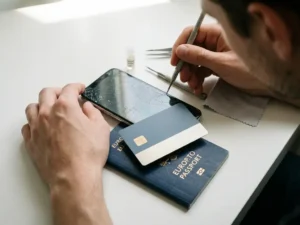 Cracked smartphone screen being repaired next to a digital identity card and EU passport on a white surface, symbolizing secure credential recovery.